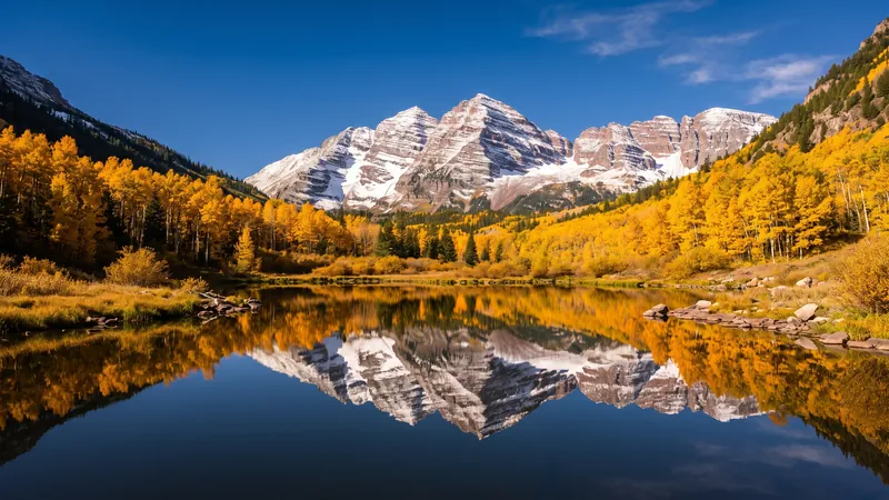 Maroon Bells reflected in Maroon Lake with golden aspens, Colorado