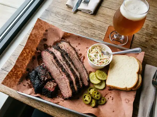Texas BBQ brisket plate on butcher paper with craft beer