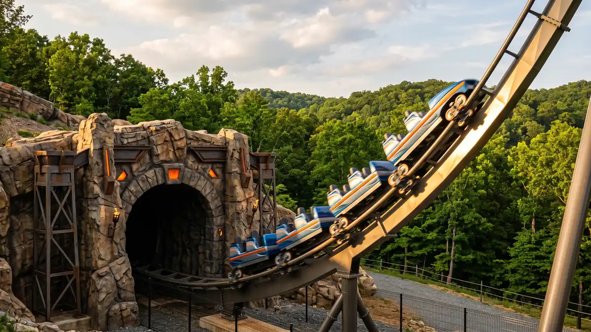 Families enjoying rides with European castle architecture and lush forest backdrop at Busch Gardens Williamsburg Virginia