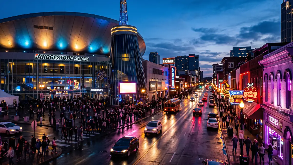 Bridgestone Arena in downtown Nashville at night with the Broadway neon lights glowing in the background