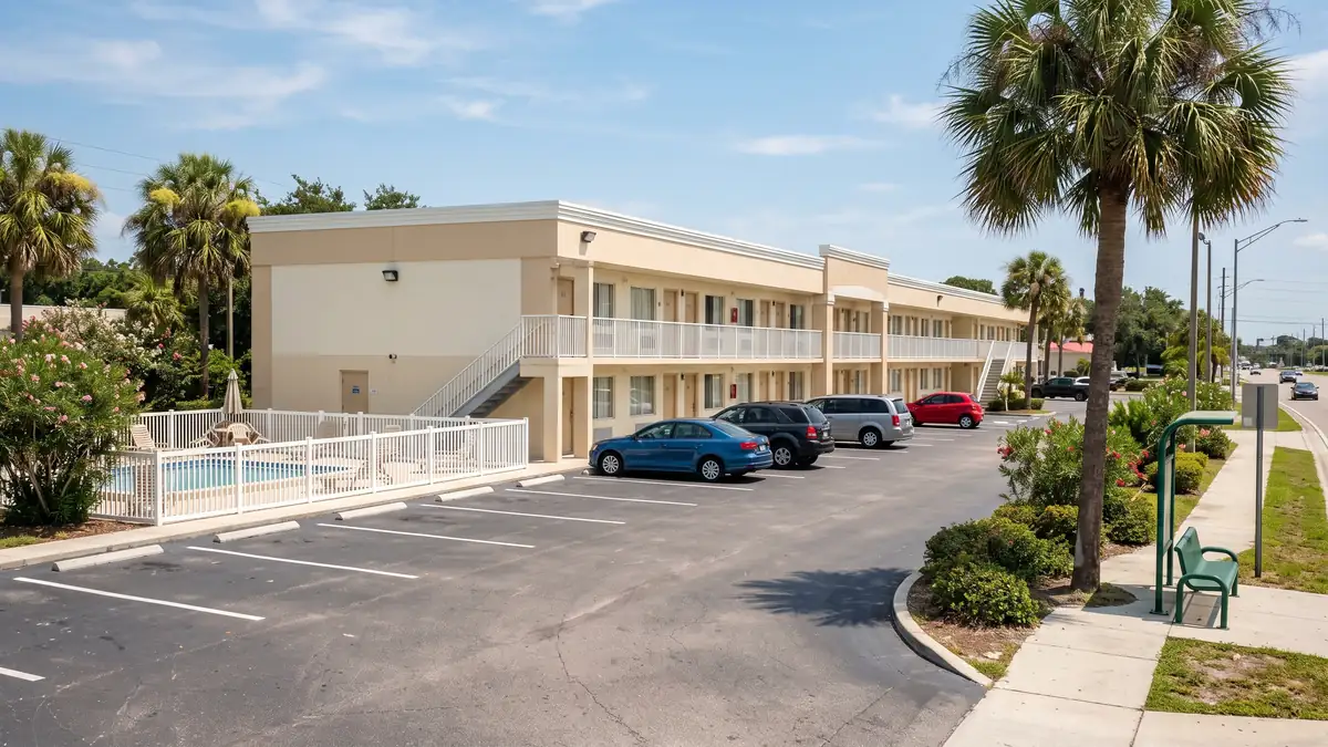 La Quinta Inn Busch Gardens exterior with parking lot and pool near Busch Gardens Tampa
