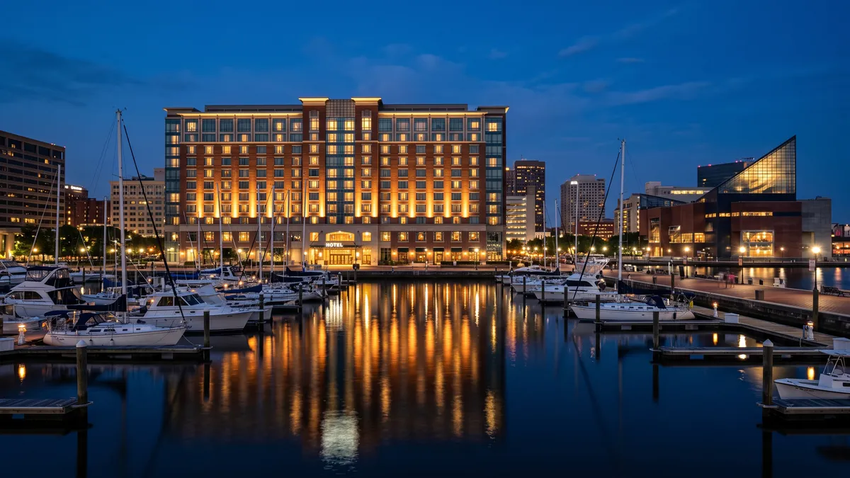 Baltimore Inner Harbor skyline at dusk with hotels visible near Camden Yards