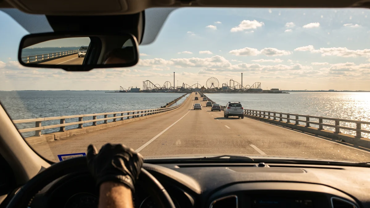 Cedar Point causeway road leading to the peninsula entrance with roller coasters visible in the distance Sandusky Ohio