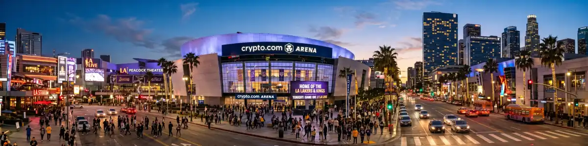 Crypto.com Arena exterior in Downtown Los Angeles at dusk with LA Live entertainment complex glowing and fans arriving