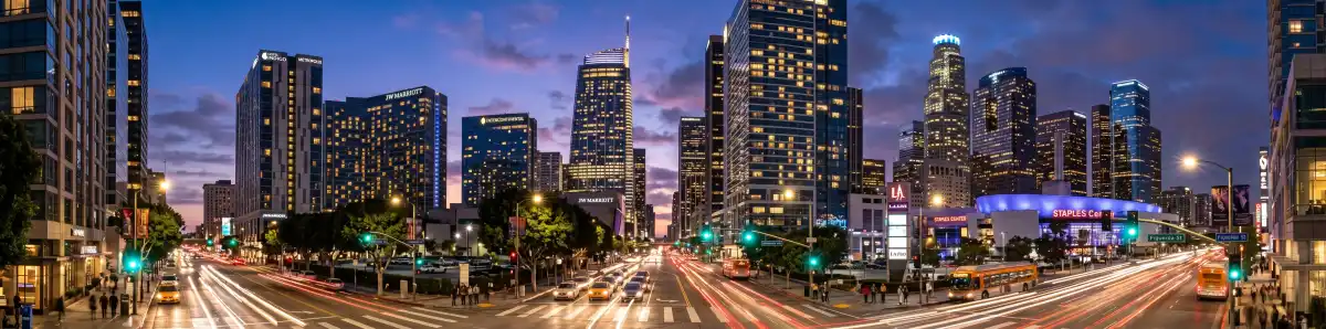 Downtown Los Angeles skyline at dusk with modern hotel towers along Figueroa Street