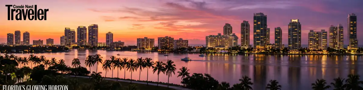 Miami Beach and Aventura skyline at dusk with hotel towers and palm trees