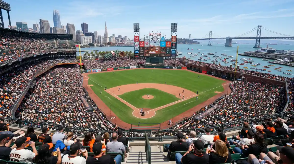 Inside Oracle Park looking across the baseball diamond with McCovey Cove and Bay Bridge visible beyond the outfield