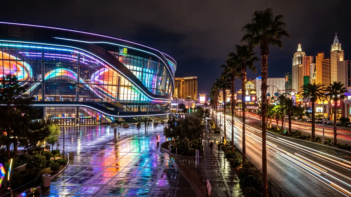 T-Mobile Arena on the Las Vegas Strip at night with Toshiba Plaza lit up before a Vegas Golden Knights game