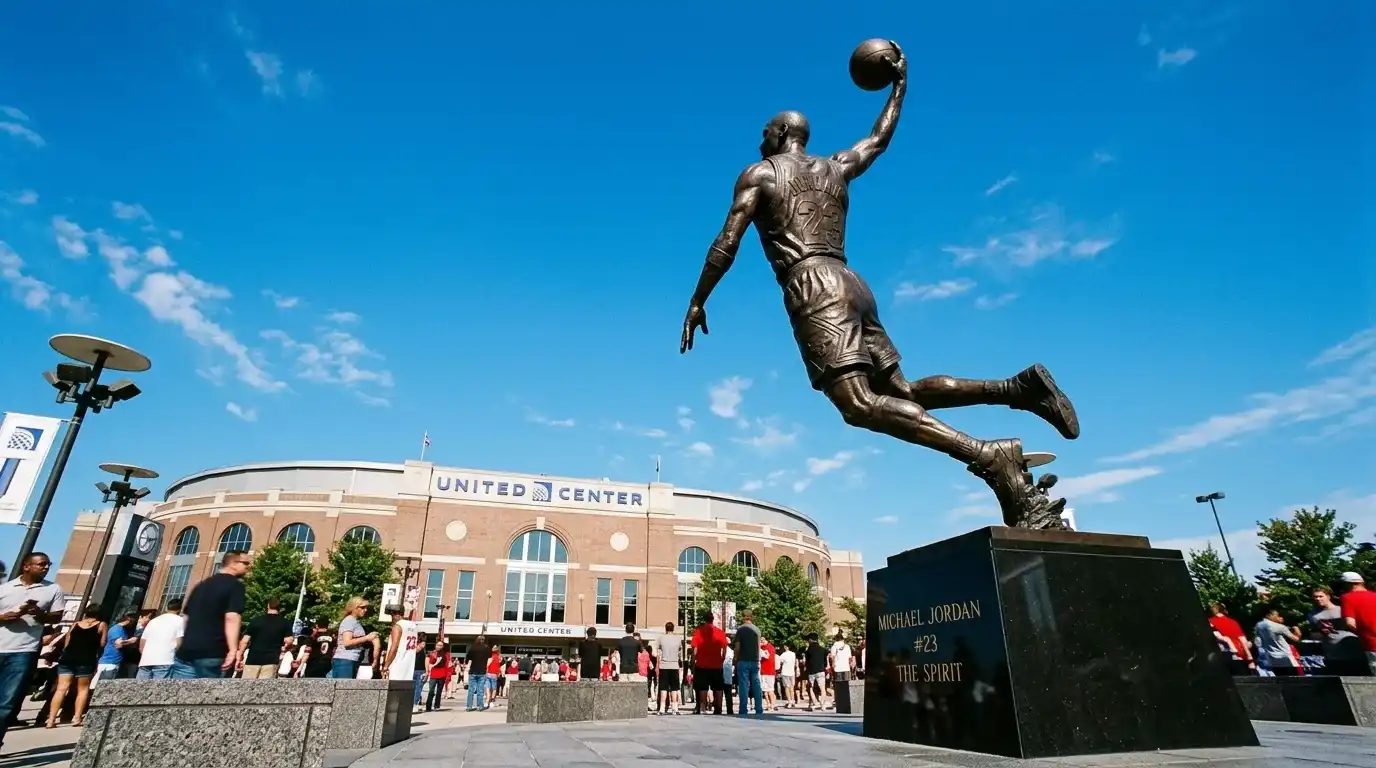 Michael Jordan statue outside the United Center at night with dramatic uplighting