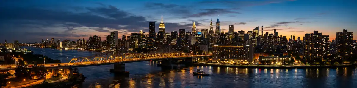 Manhattan skyline at dusk viewed from the Bronx with city lights and bridges